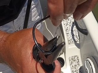 Making a hook barbless by using pliers to crimp down the barb Making a hook barbless by using pliers to crimp down the barb